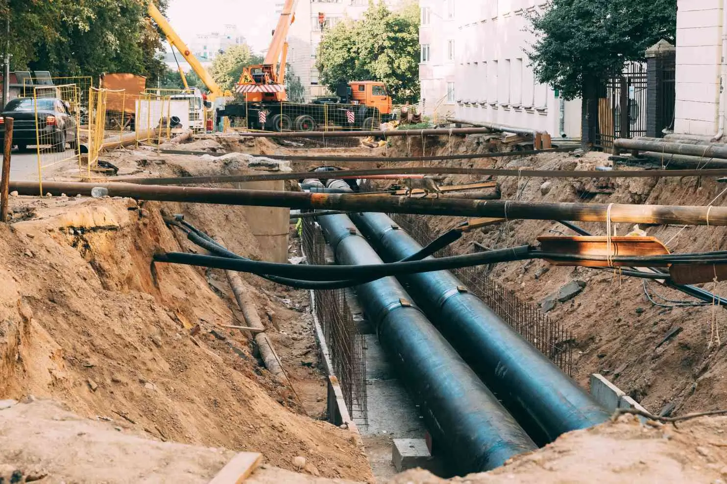 Construction site with exposed underground pipes