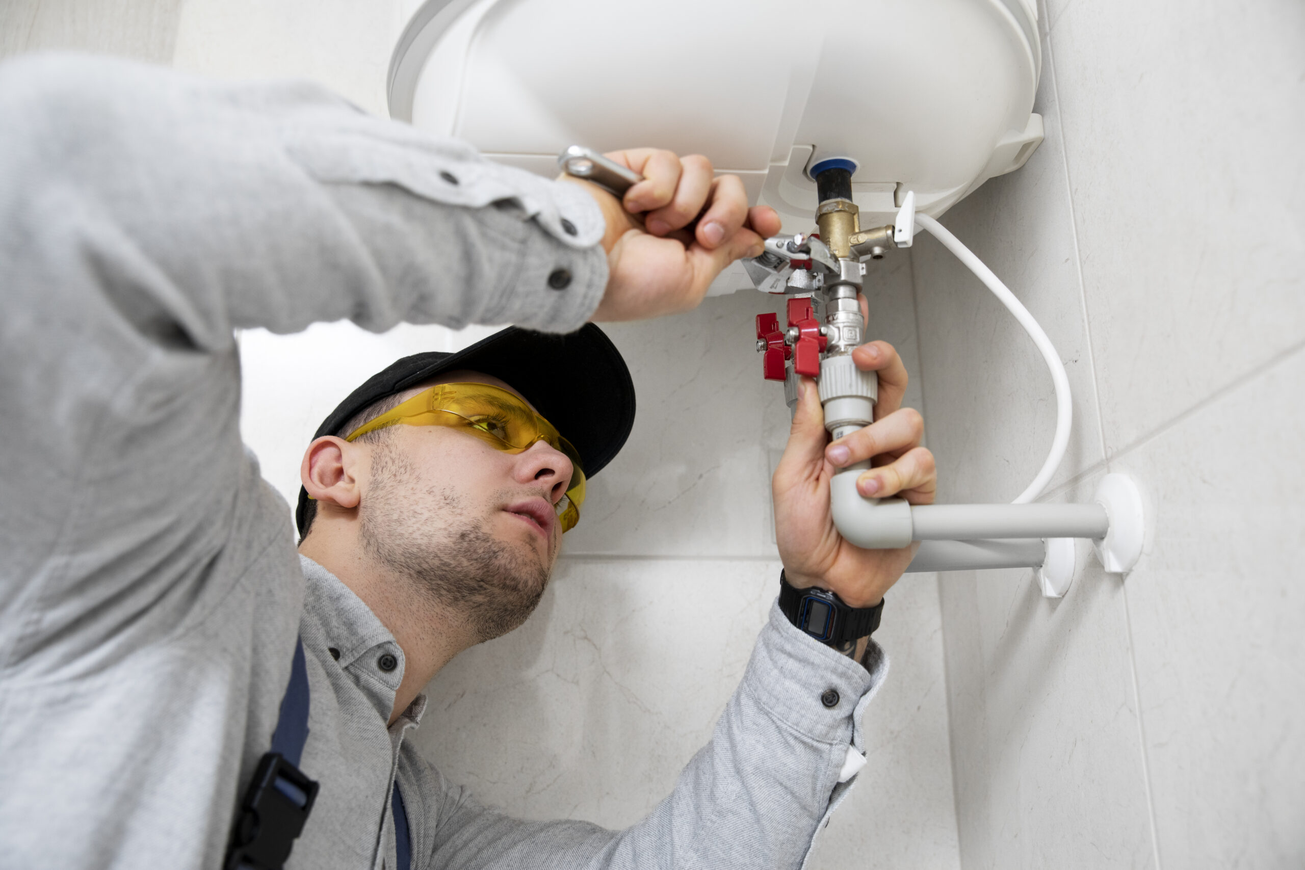 Person fixing a water heater.