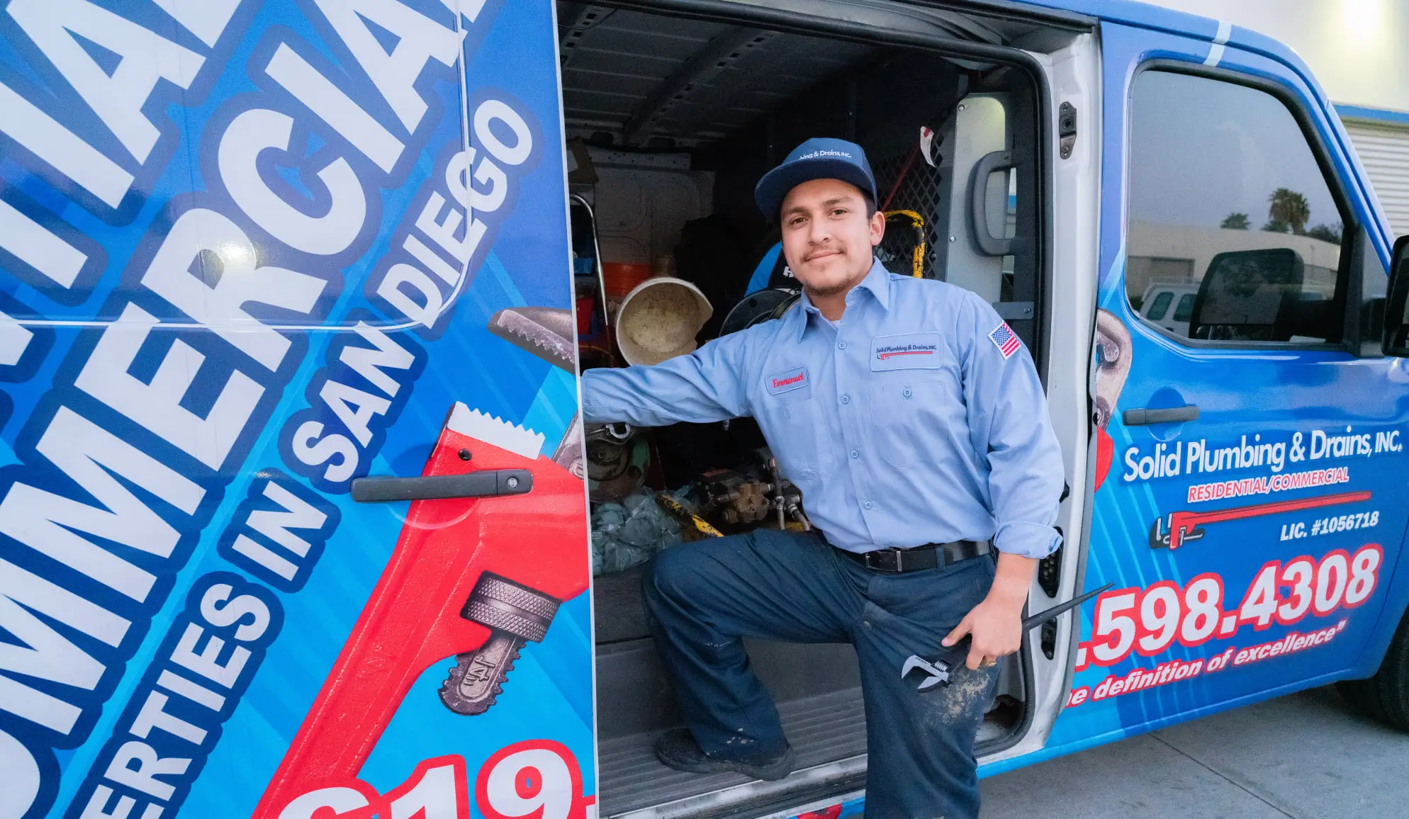 Solid Plumbing & Drains team member beside a service truck in San Diego
