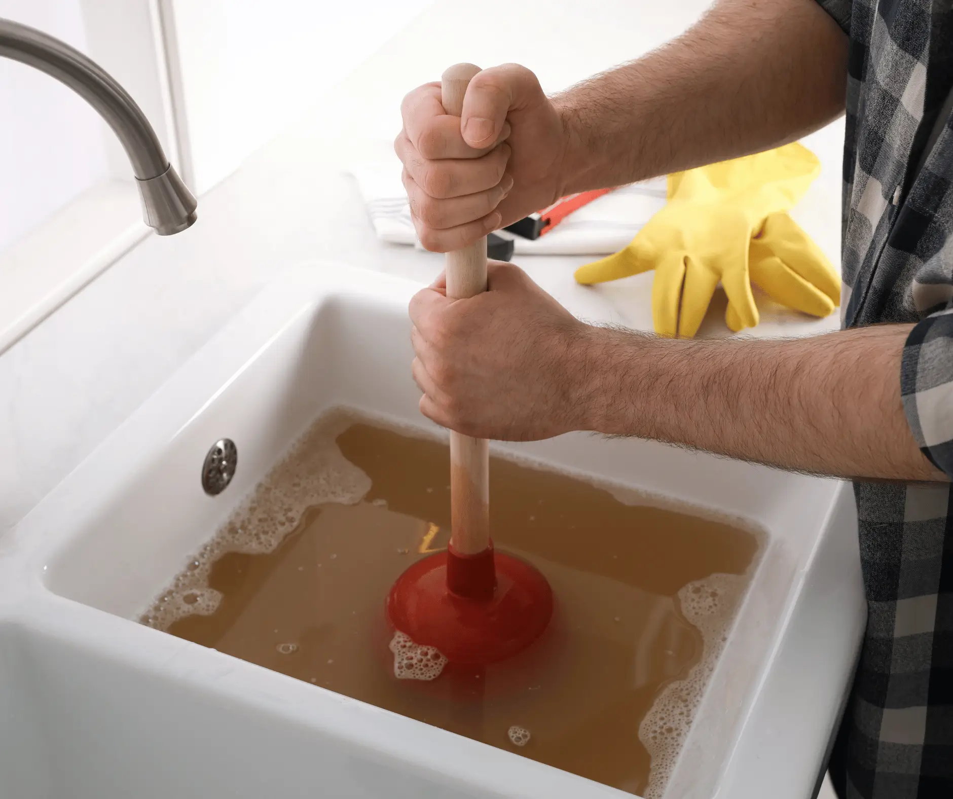 Using Plunger to Unclog Sink Drain in Kitchen, Closeup