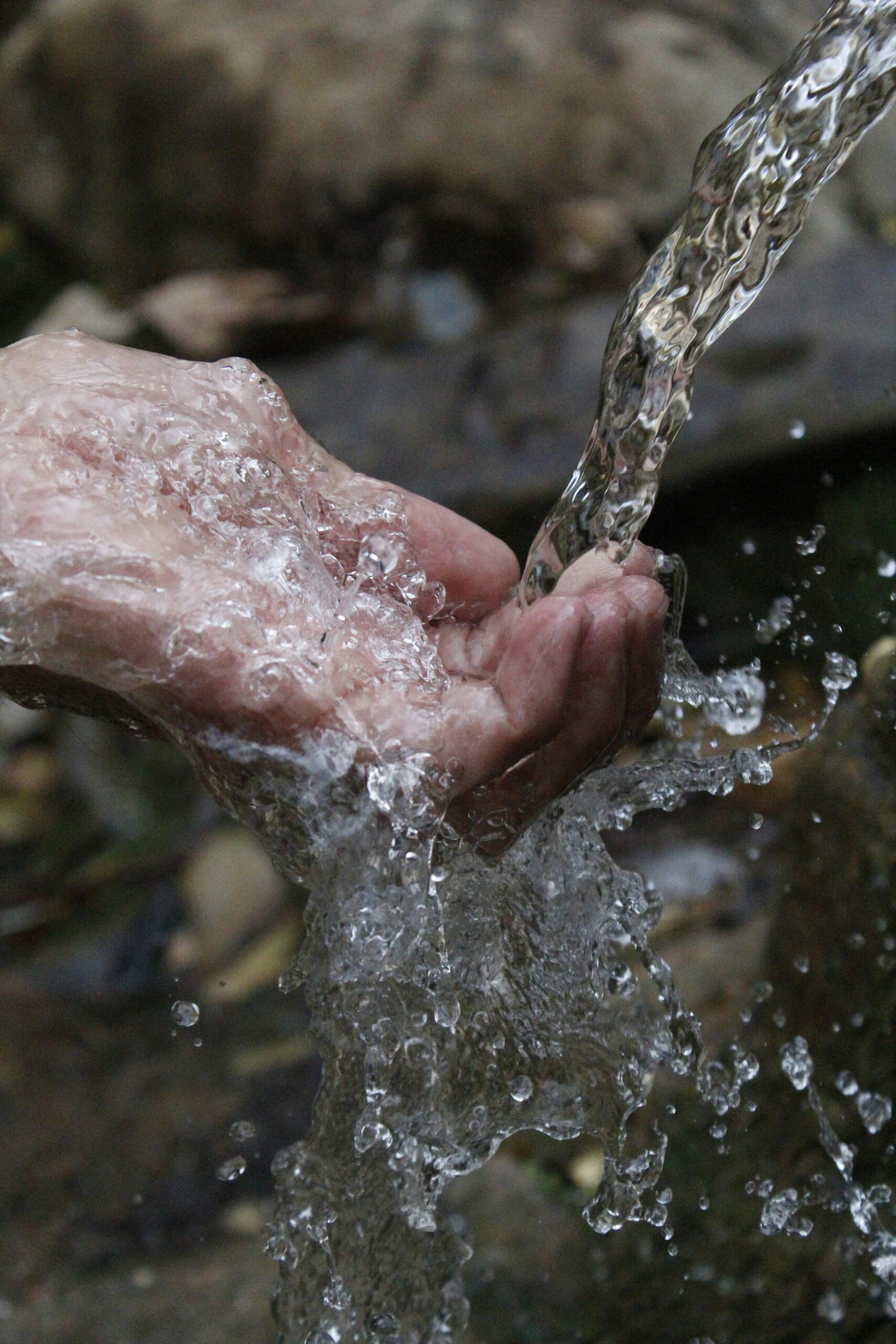 Hand catching flowing water