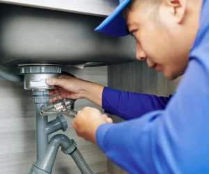 Plumber Repairing a Leaky Drain