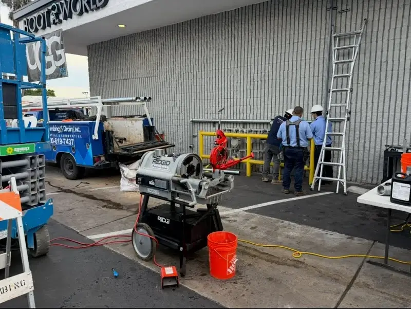 Solid Plumbing technicians and drain equipment at a commercial job site