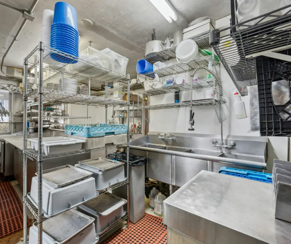 Commercial kitchen with stainless steel sinks and prep equipment