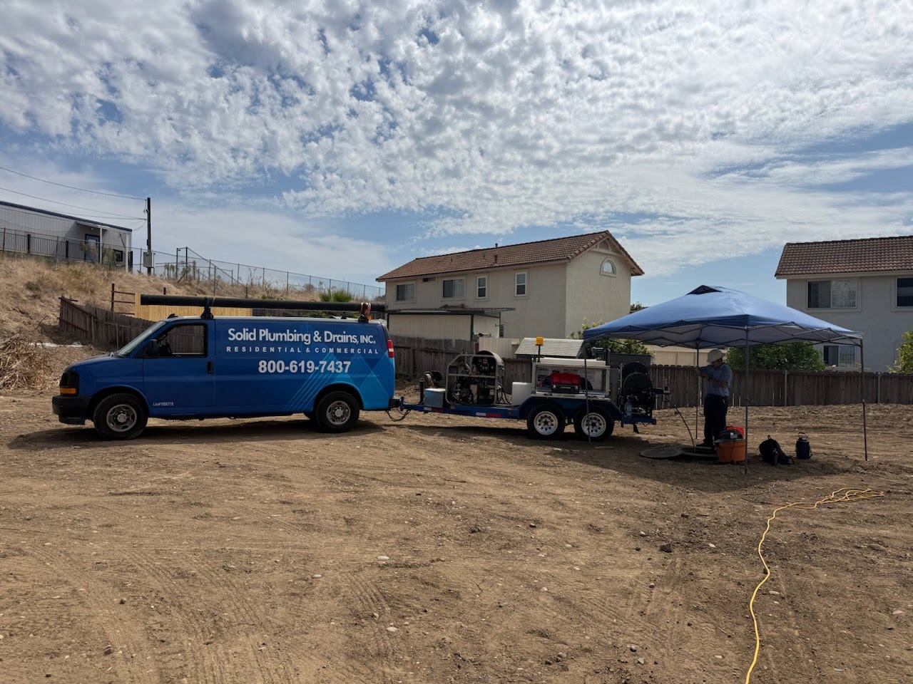 Solid Plumbing sewer service crew and equipment at a residential jobsite