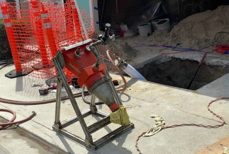 Sewer pipe lining equipment set up at an underground sewer access point