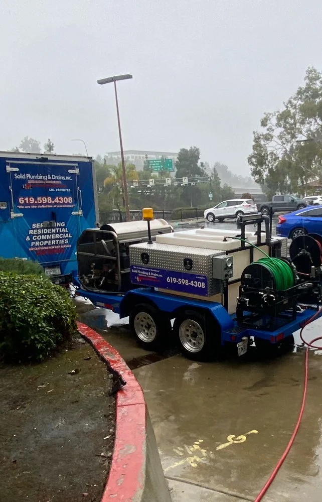 Emergency plumbing crew and equipment at a wet-weather service call