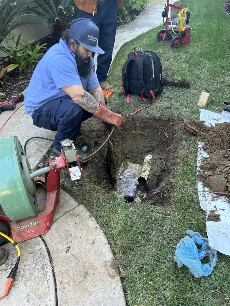 Plumber cleaning and preparing a sewer line for pipe lining service